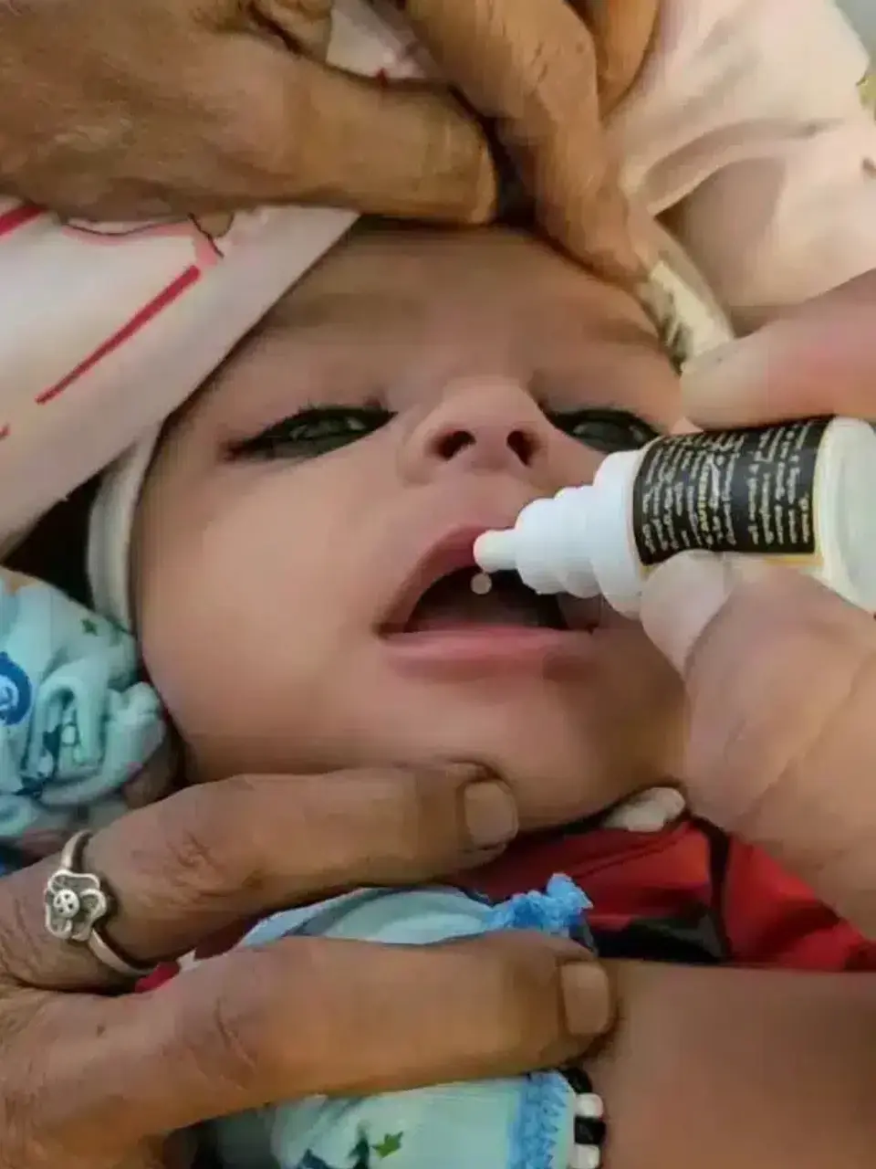 Child taking Suvarnaprashan